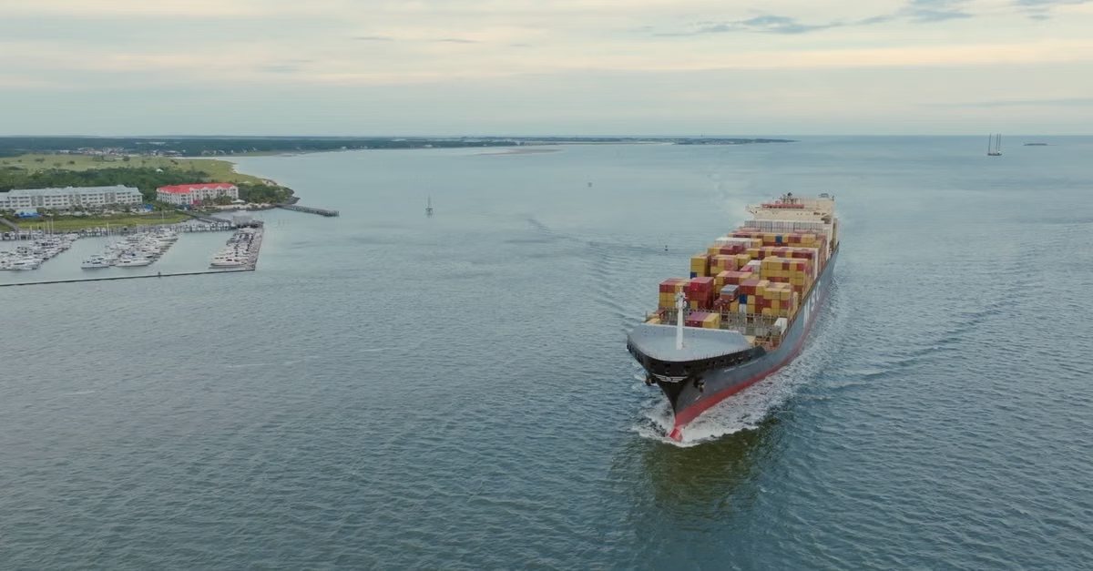 Container ship sailing along the coast