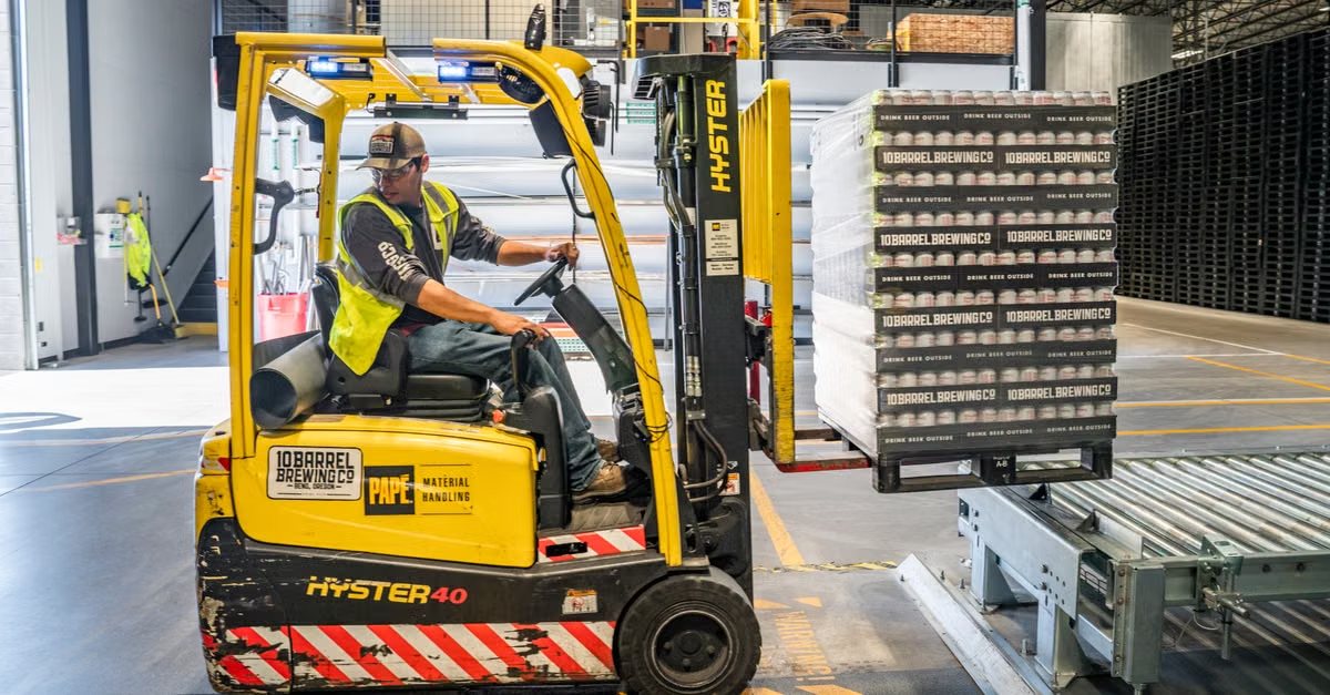 Forklift moving palletised goods in a warehouse